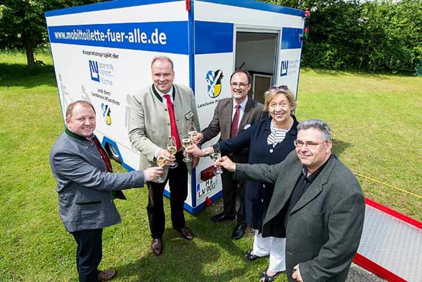 Foto: Menschen vor barrierefreiem Toiletten-Wagen